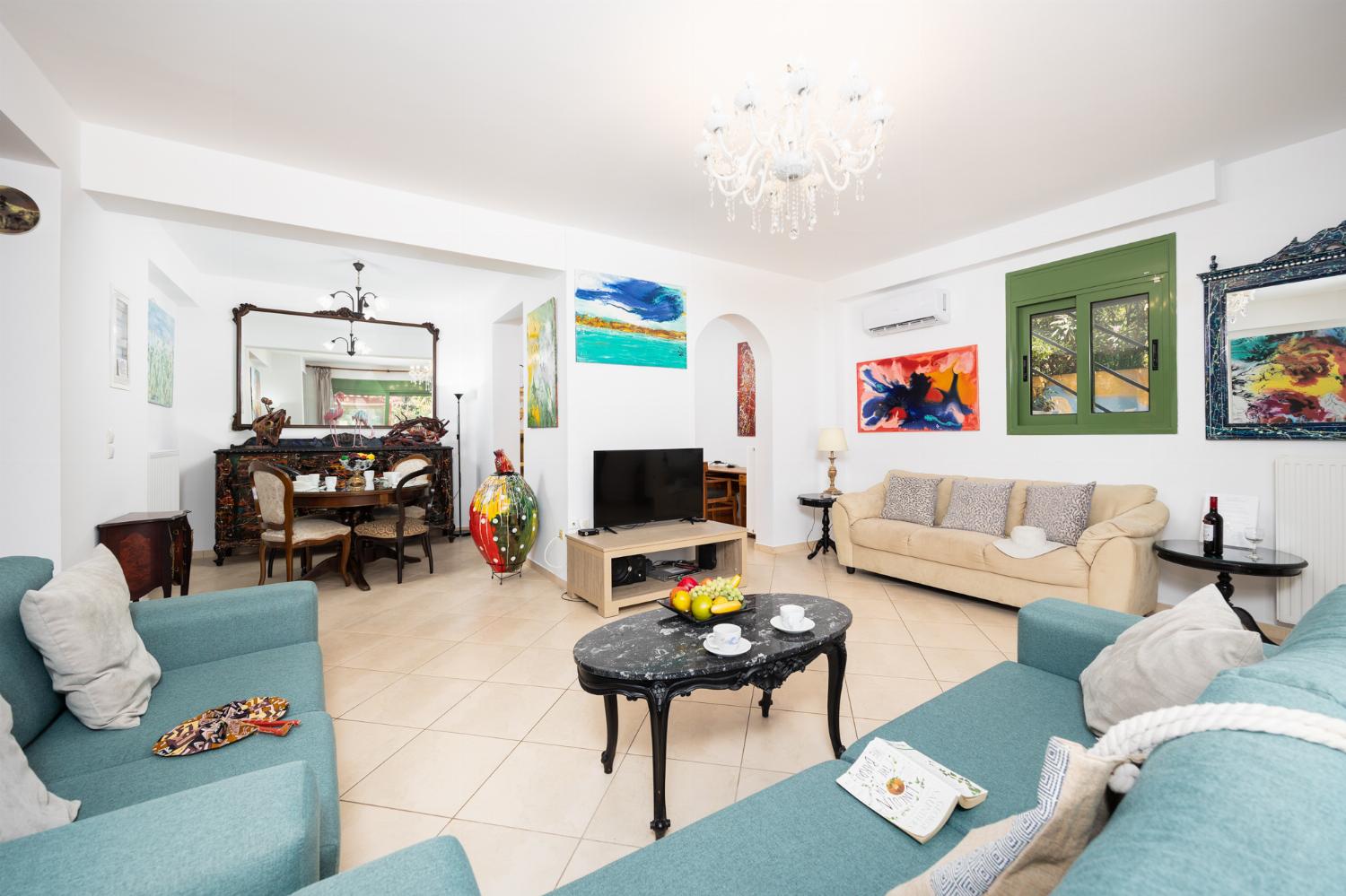 Living room with sofas, dining area, A/C, WiFi internet, and satellite TV
