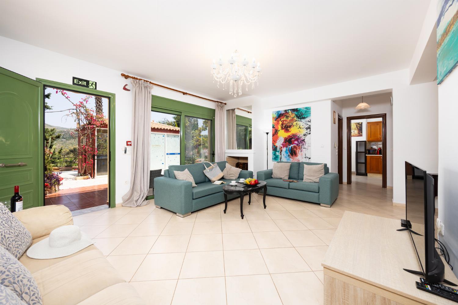 Living room with sofas, dining area, A/C, WiFi internet, and satellite TV