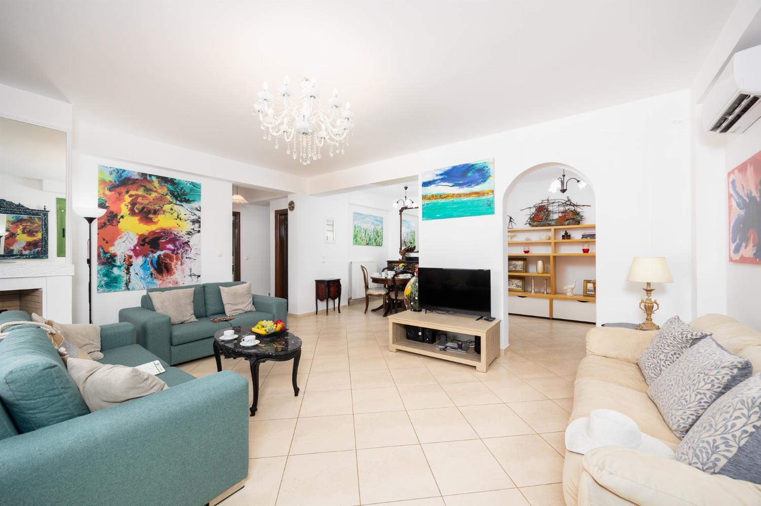 Living room with sofas, dining area, A/C, WiFi internet, and satellite TV