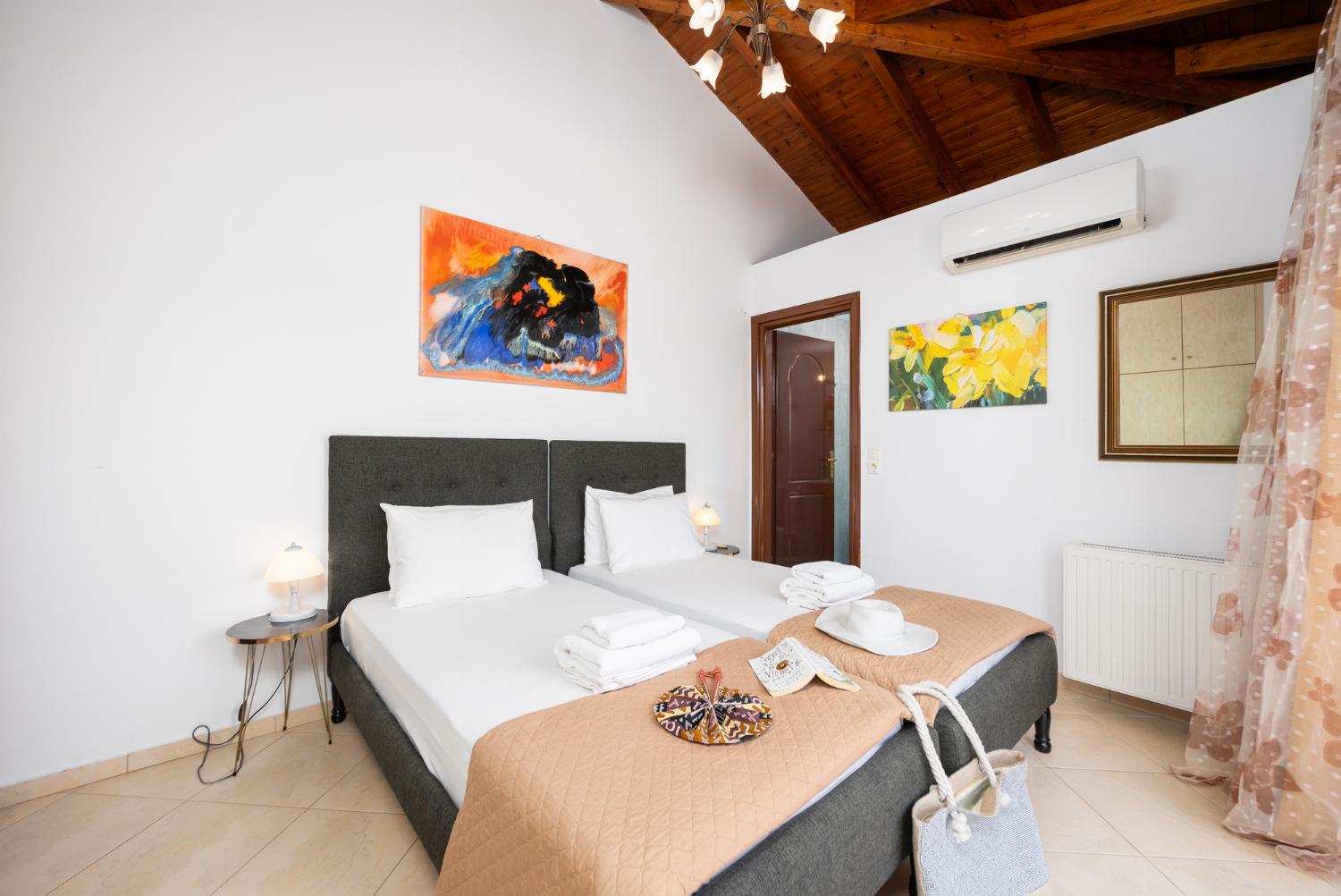 Twin bedroom with en suite bathroom and A/C