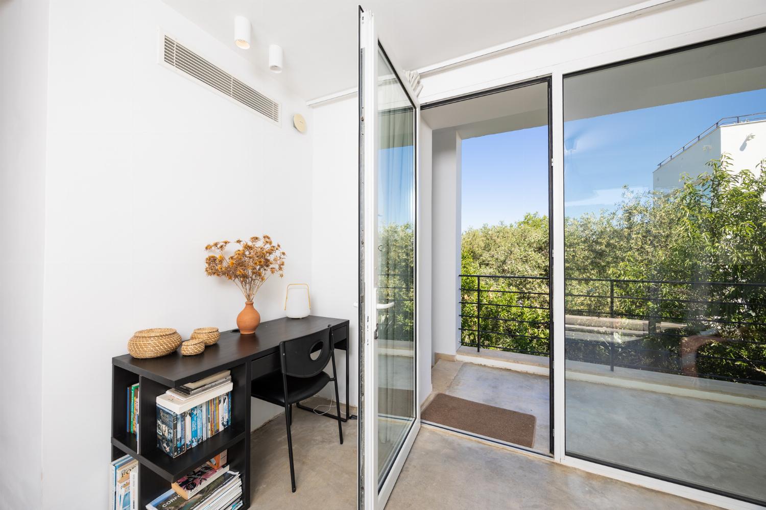 Open-plan living room with sofa, dining area, kitchen, A/C, WiFi internet, and satellite TV