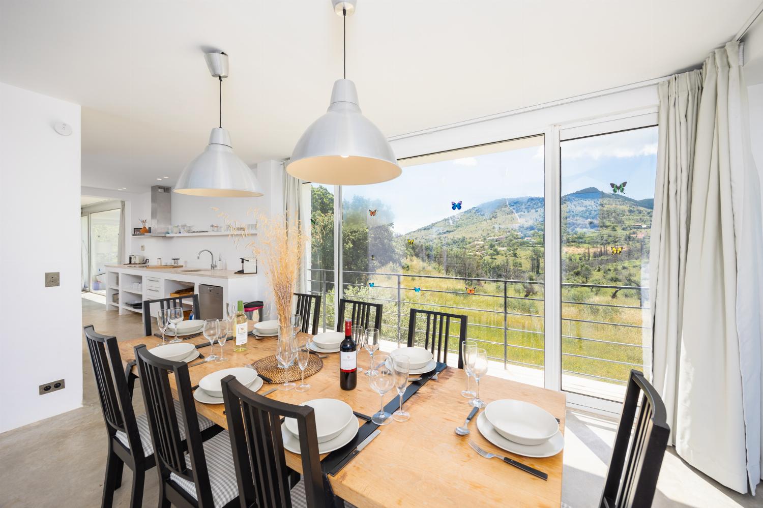 Open-plan living room with sofa, dining area, kitchen, A/C, WiFi internet, and satellite TV