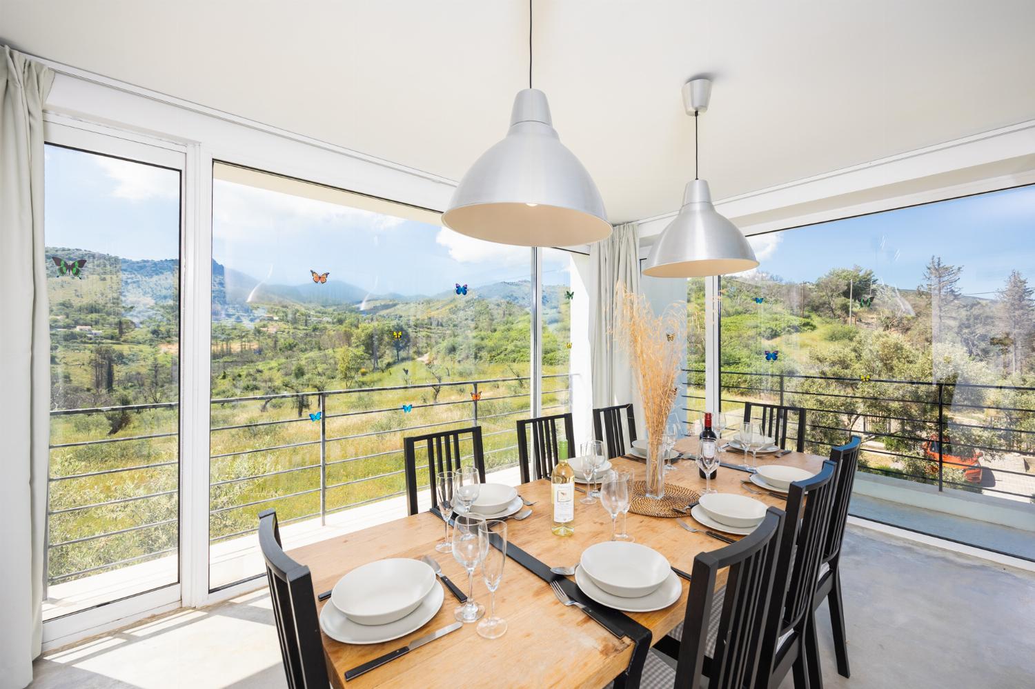Open-plan living room with sofa, dining area, kitchen, A/C, WiFi internet, and satellite TV