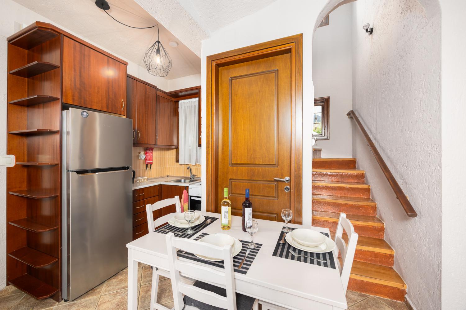 Unit 1: open-plan living room with sofa, dining area, kitchen, A/C, WiFi internet, and satellite TV