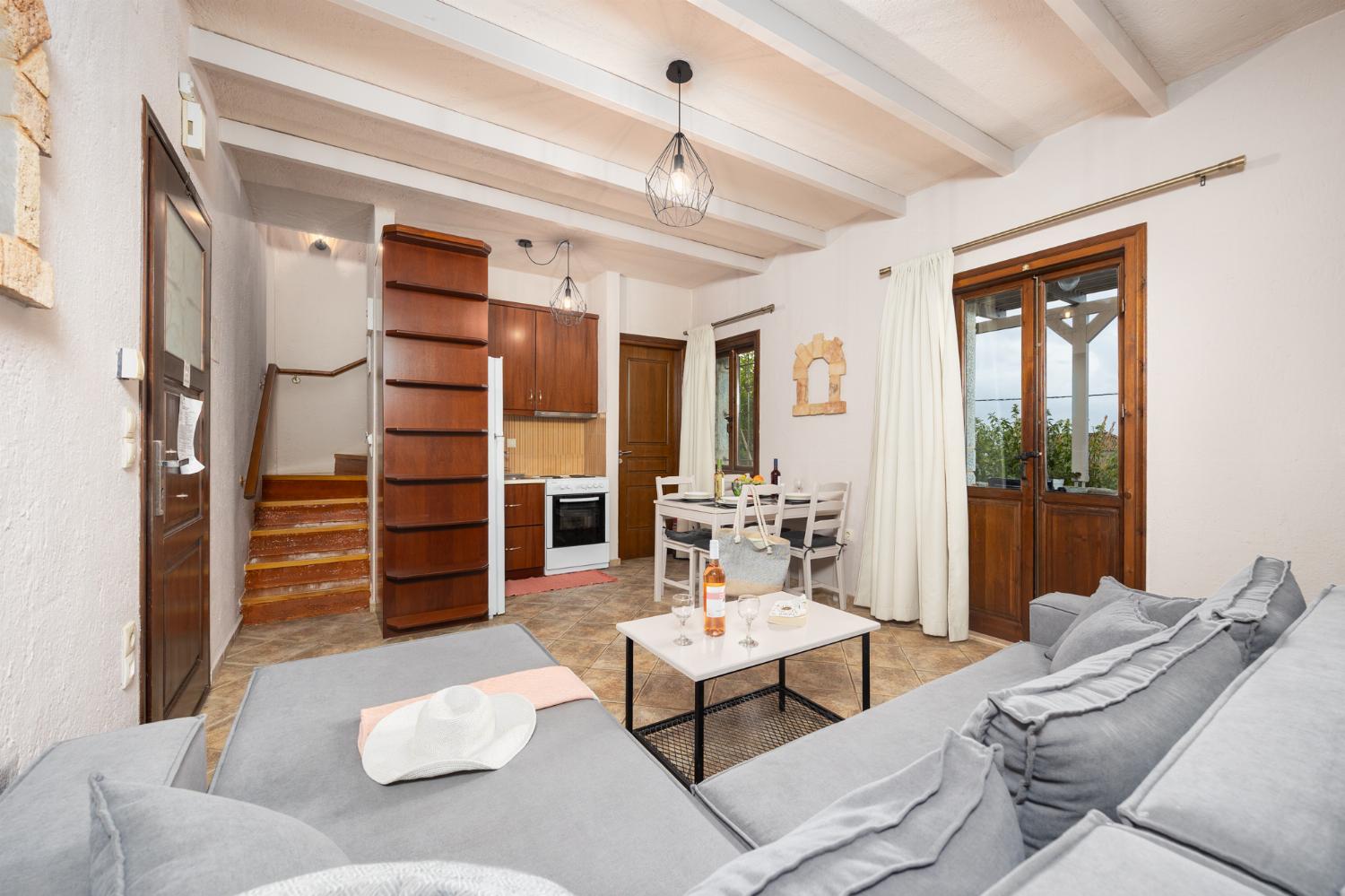 Unit 2: open-plan living room with sofa, dining area, kitchen, A/C, WiFi internet, and satellite TV