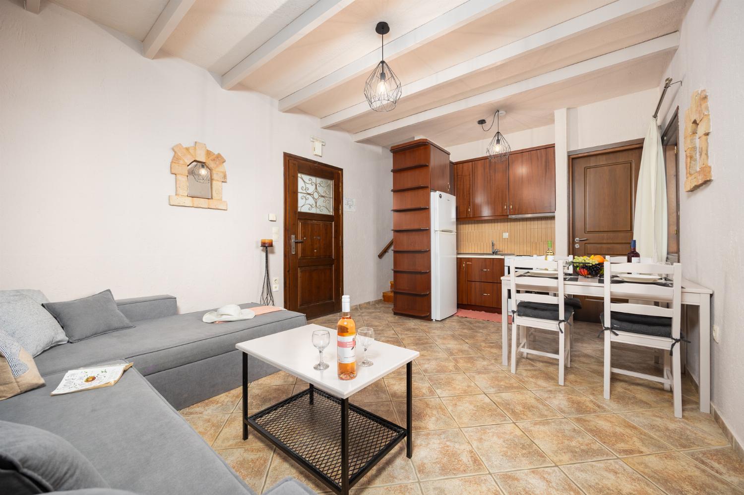 Unit 2: open-plan living room with sofa, dining area, kitchen, A/C, WiFi internet, and satellite TV