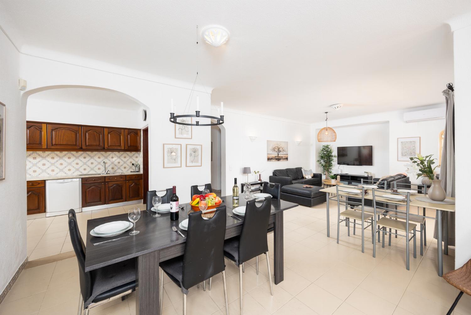 Living room with sofas, dining area, ornamental fireplace, A/C, WiFi internet, and satellite TV