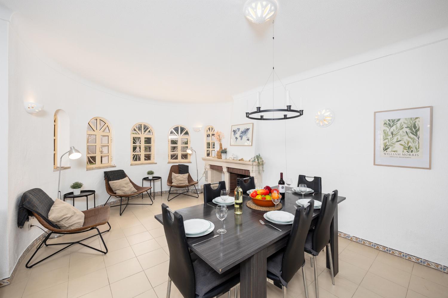 Living room with sofas, dining area, ornamental fireplace, A/C, WiFi internet, and satellite TV