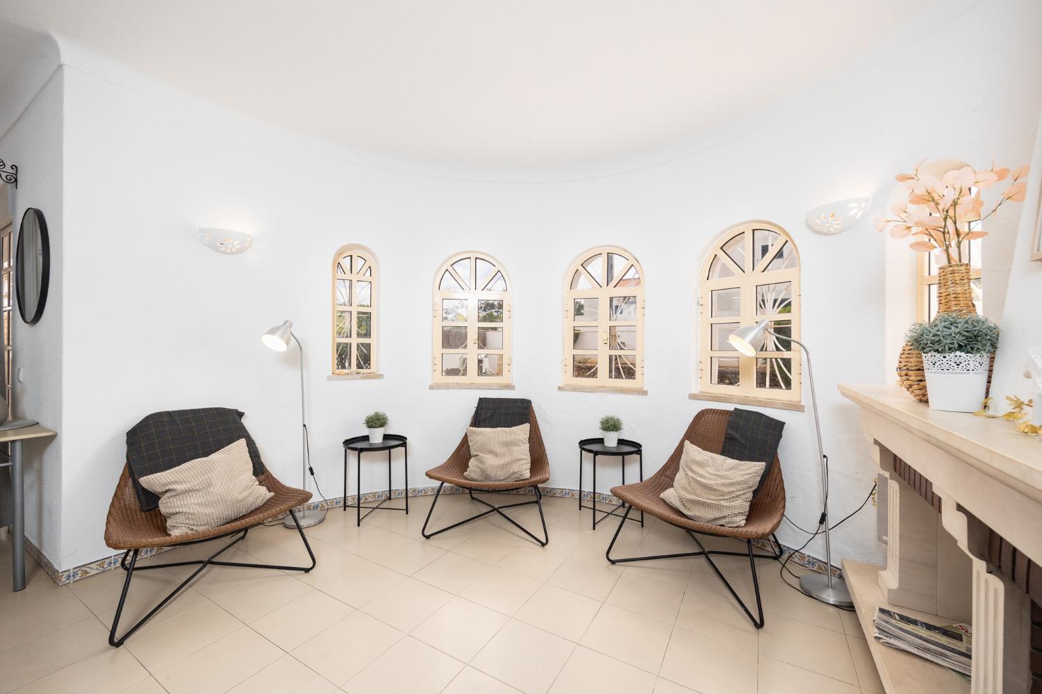Living room with sofas, dining area, ornamental fireplace, A/C, WiFi internet, and satellite TV
