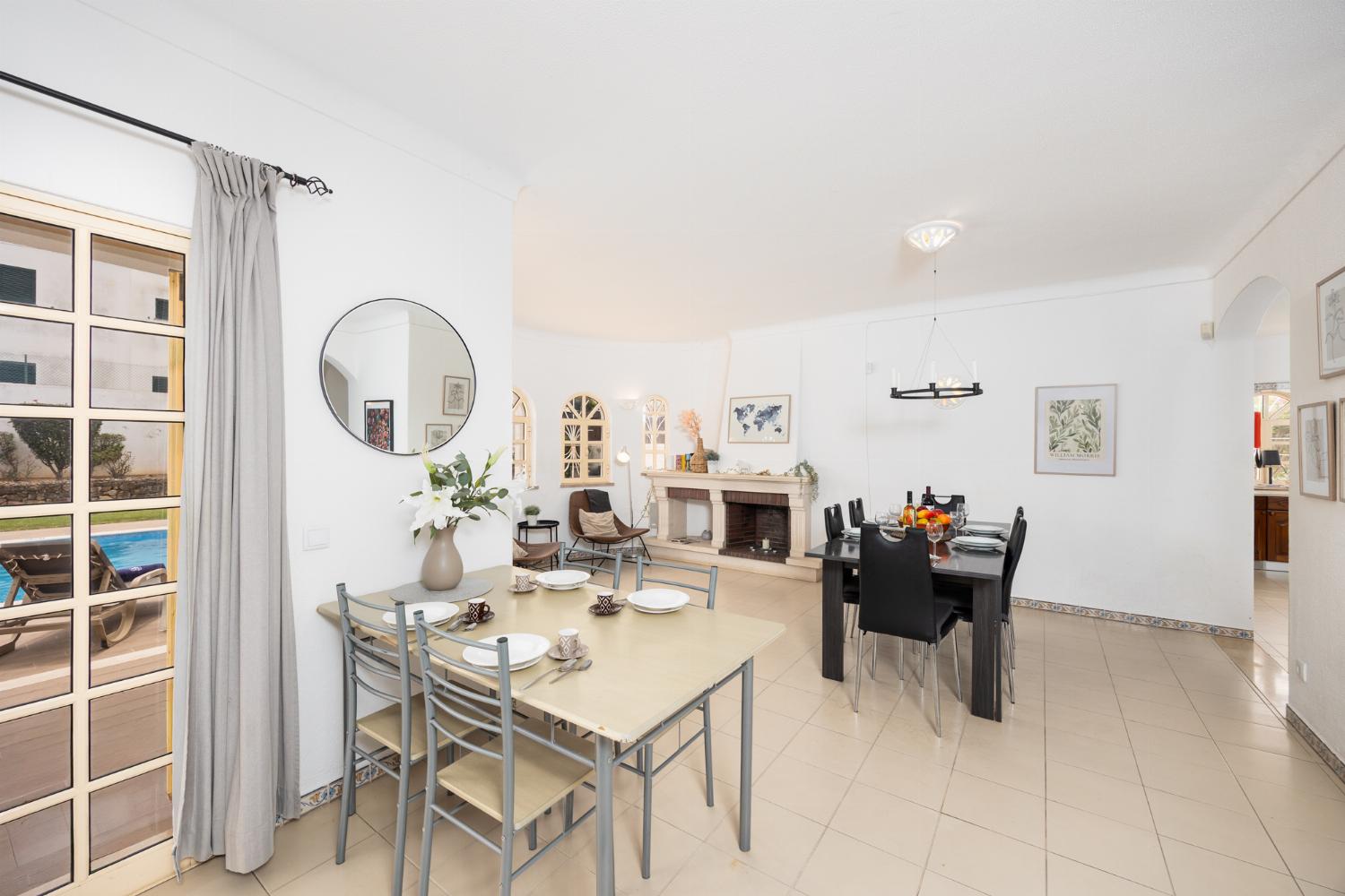 Living room with sofas, dining area, ornamental fireplace, A/C, WiFi internet, and satellite TV