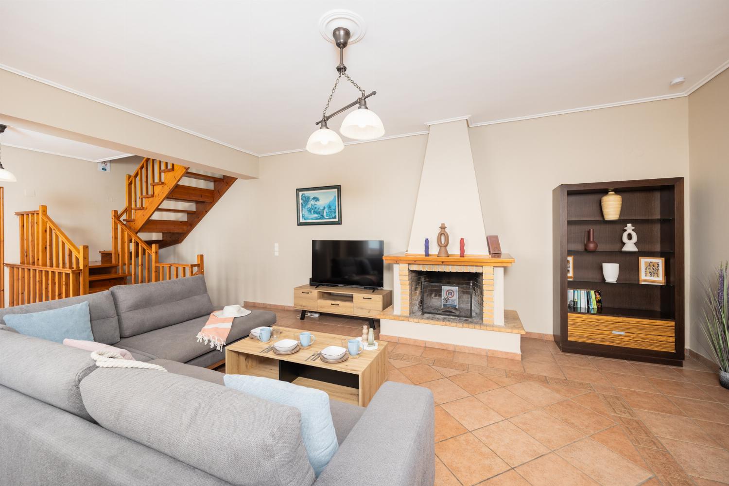 Living room with sofa, ornamental fireplace, A/C, WiFi internet, satellite TV, and sea views