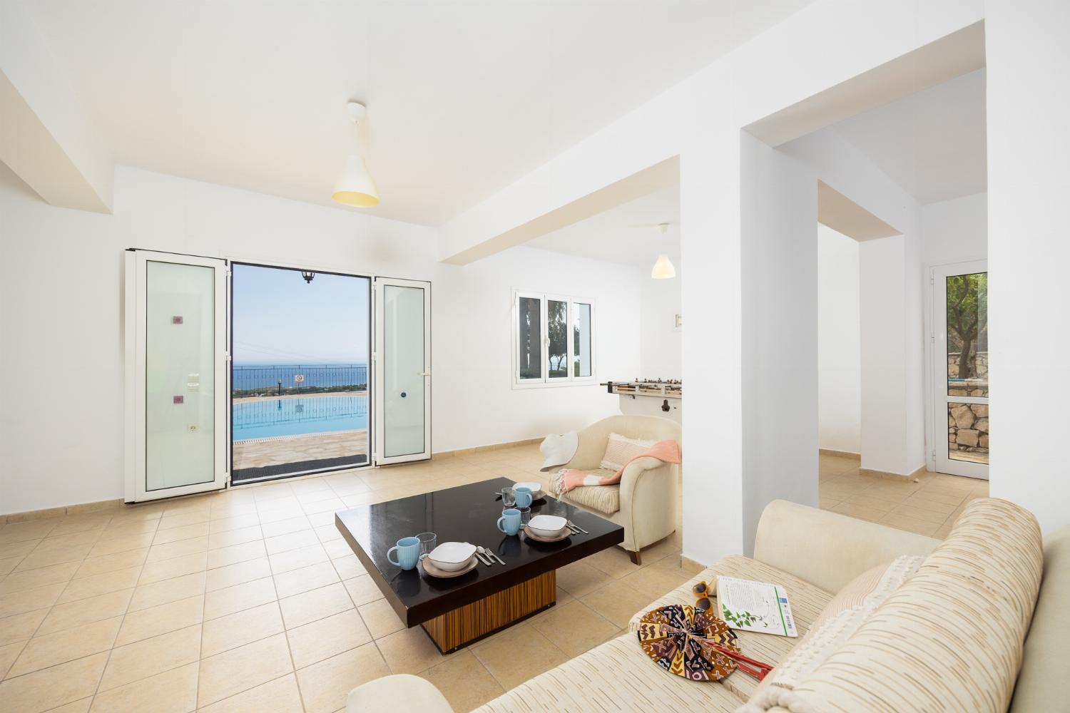 Games room with living area, pool table, foosball table, and table tennis