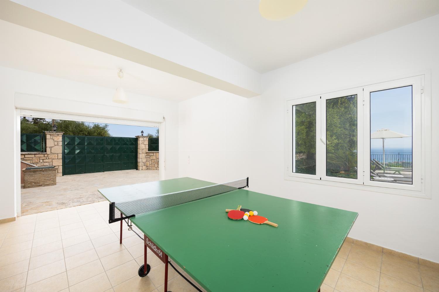Games room with living area, pool table, foosball table, and table tennis