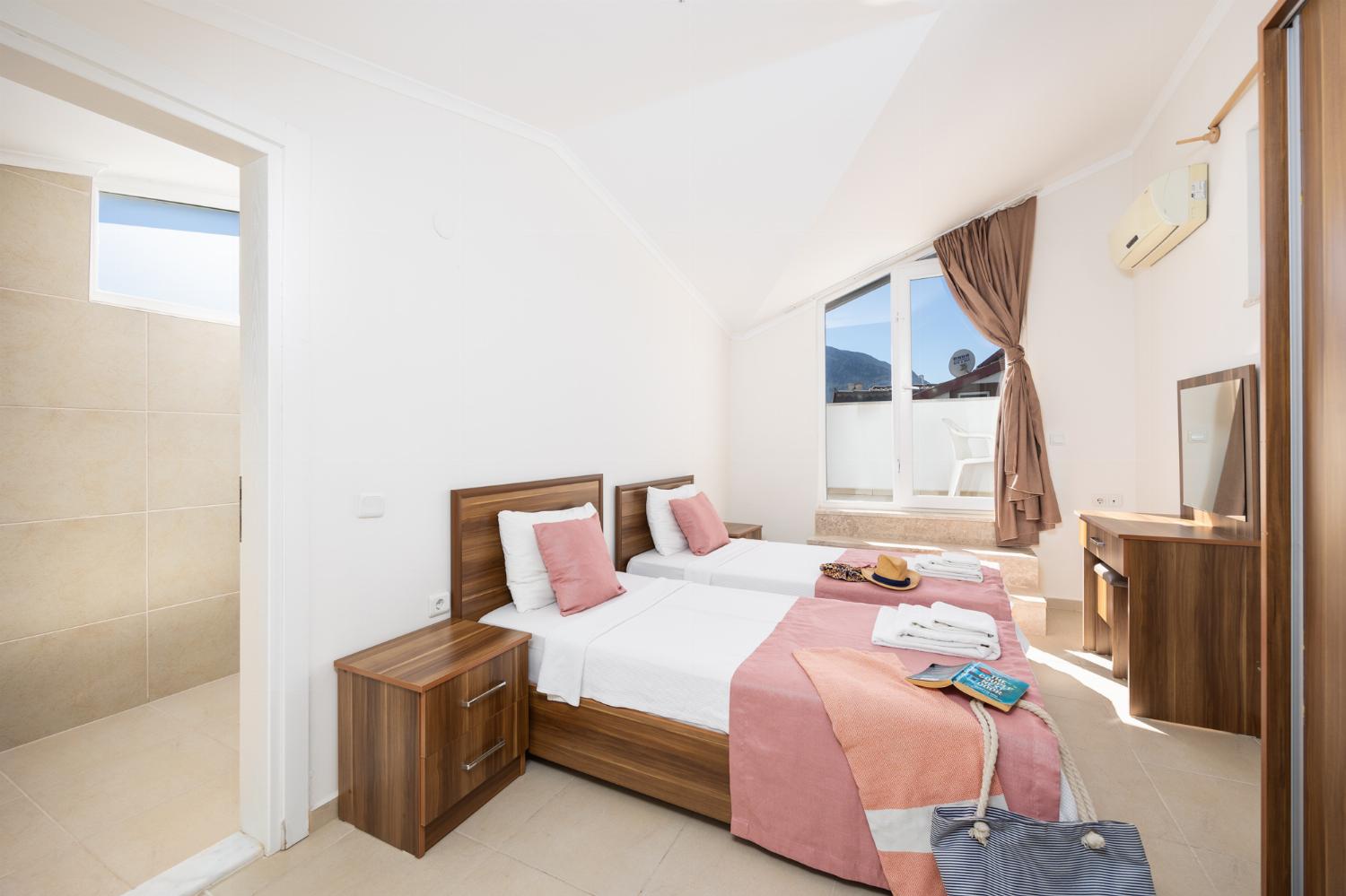 Twin bedroom with en suite bathroom and A/C