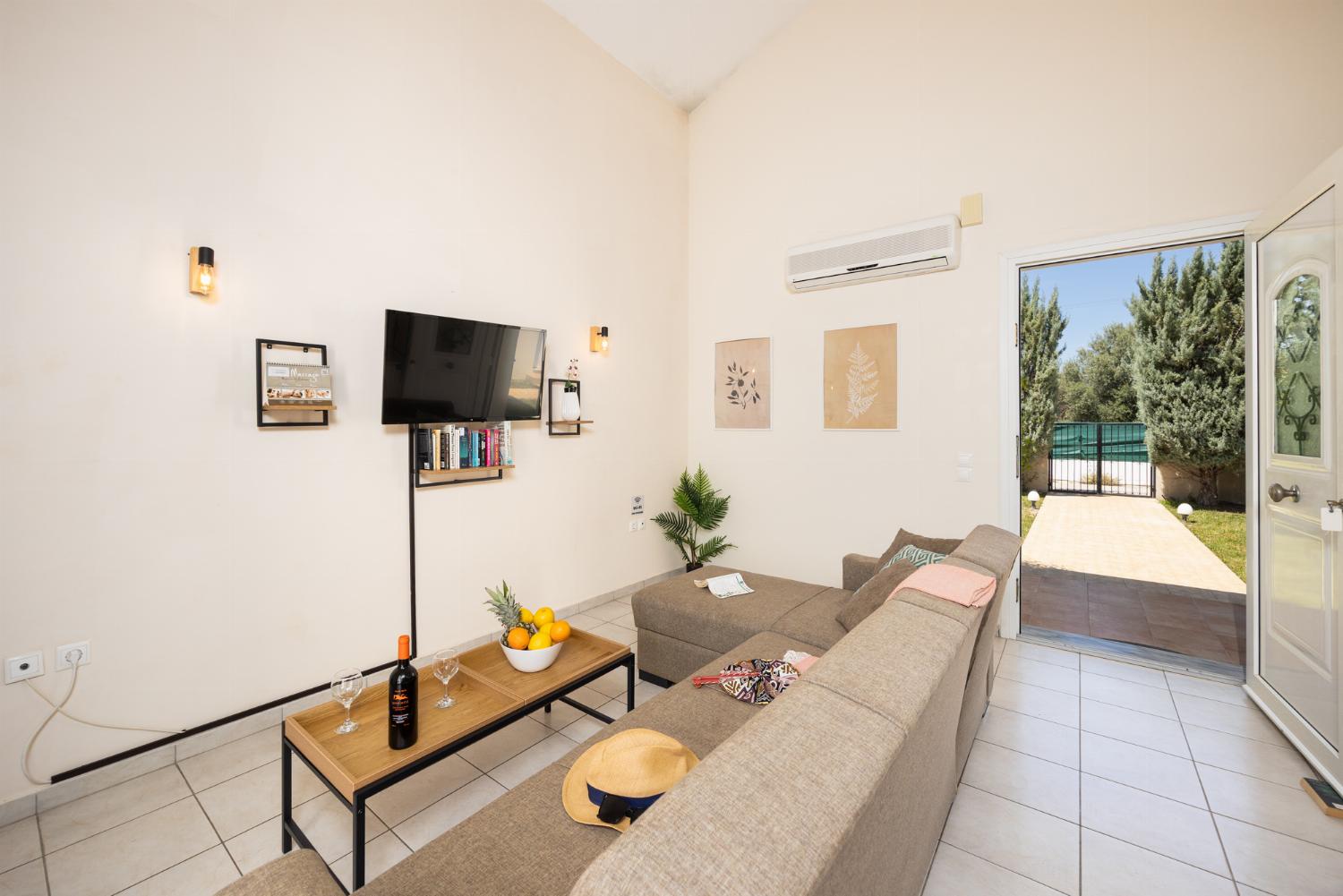 Living room with sofa, A/C, WiFi internet, and satellite TV