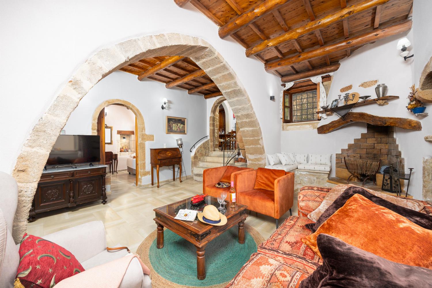 Living room with sofa, ornamental fireplace, A/C, WiFi internet, and satellite TV