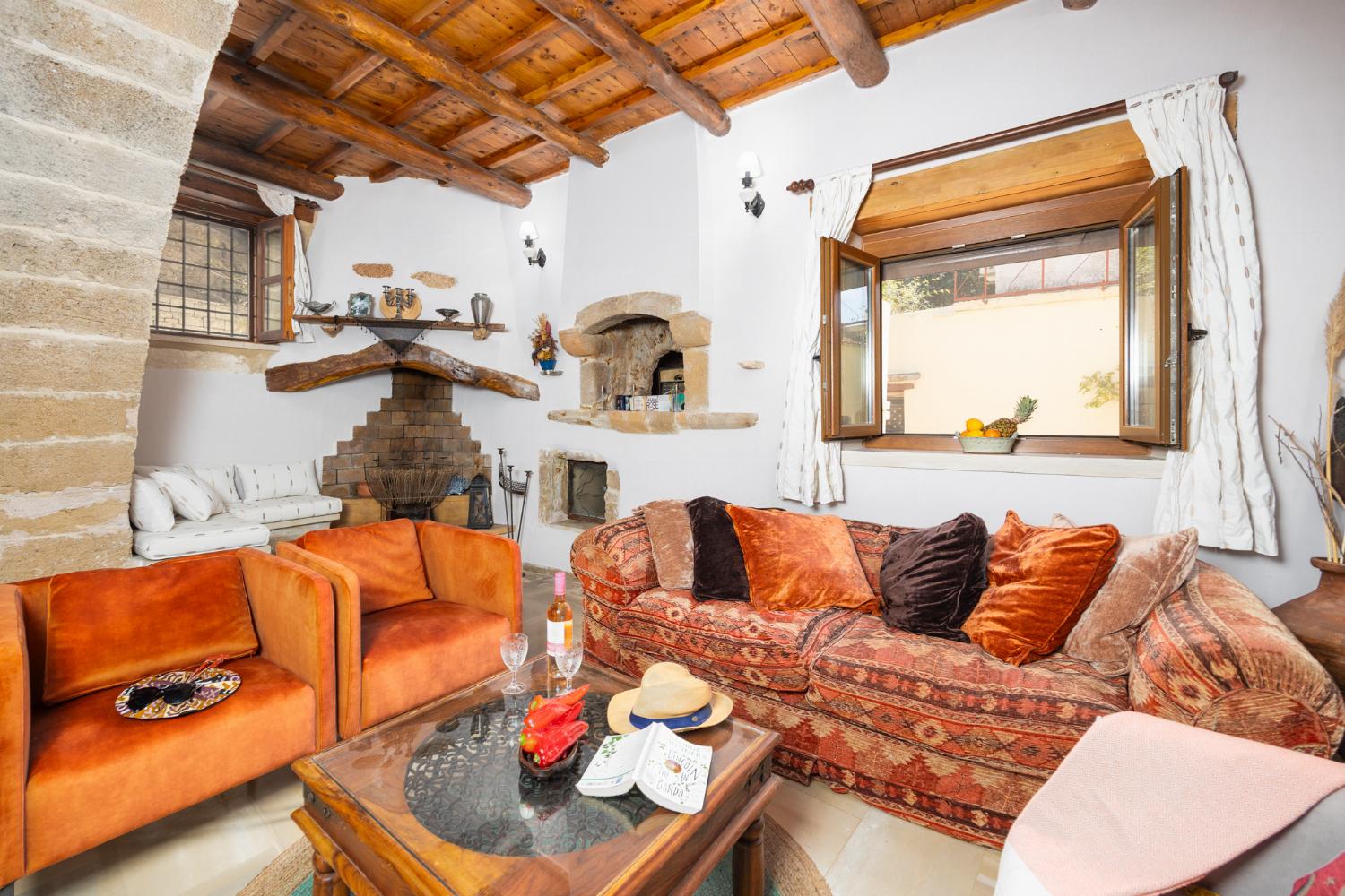 Living room with sofa, ornamental fireplace, A/C, WiFi internet, and satellite TV