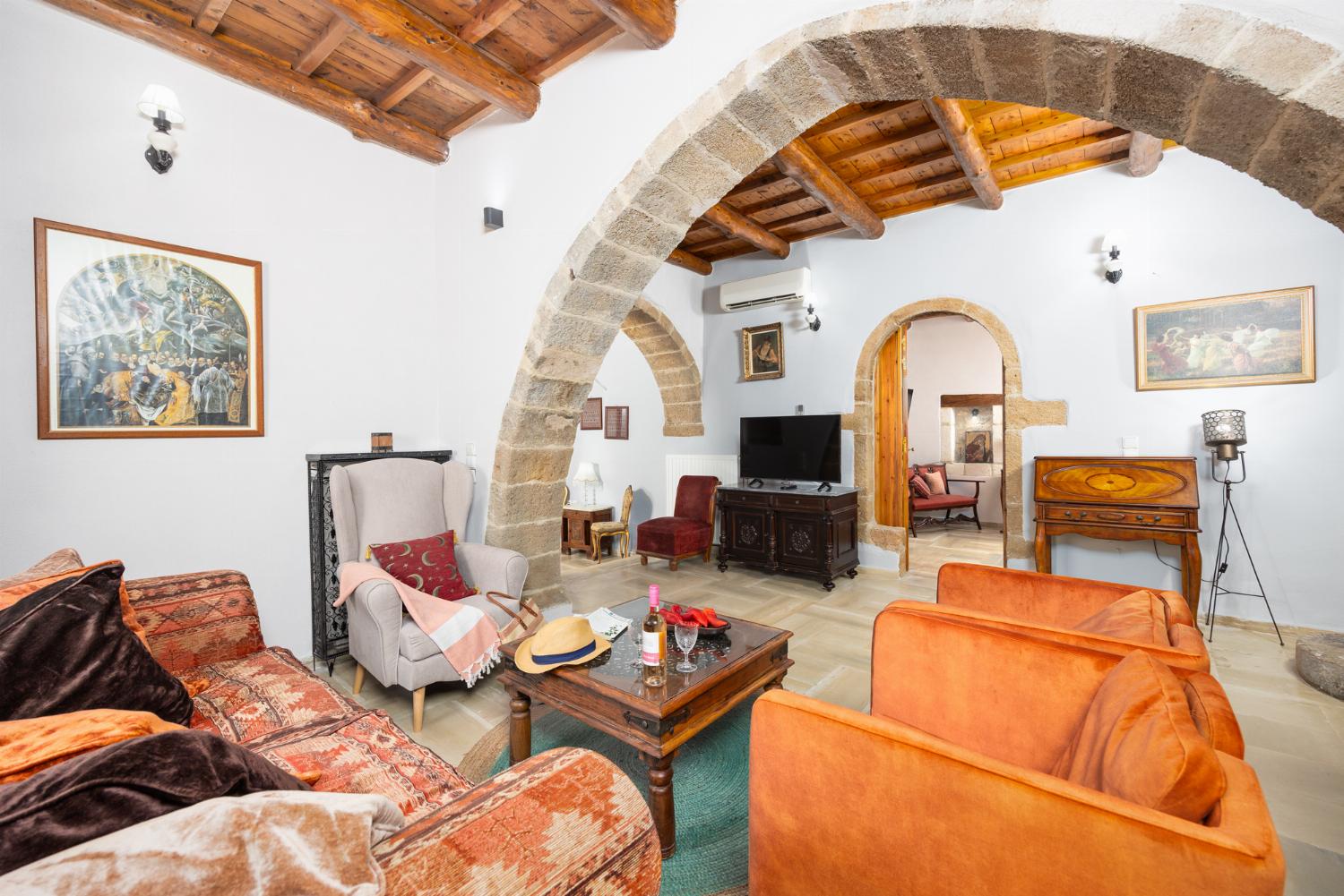 Living room with sofa, ornamental fireplace, A/C, WiFi internet, and satellite TV