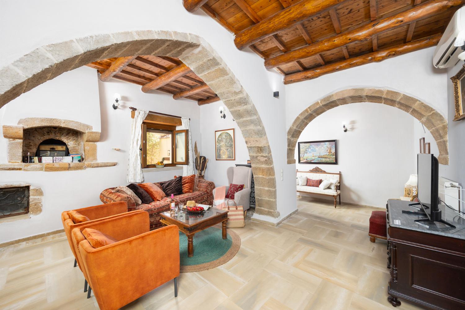 Living room with sofa, ornamental fireplace, A/C, WiFi internet, and satellite TV