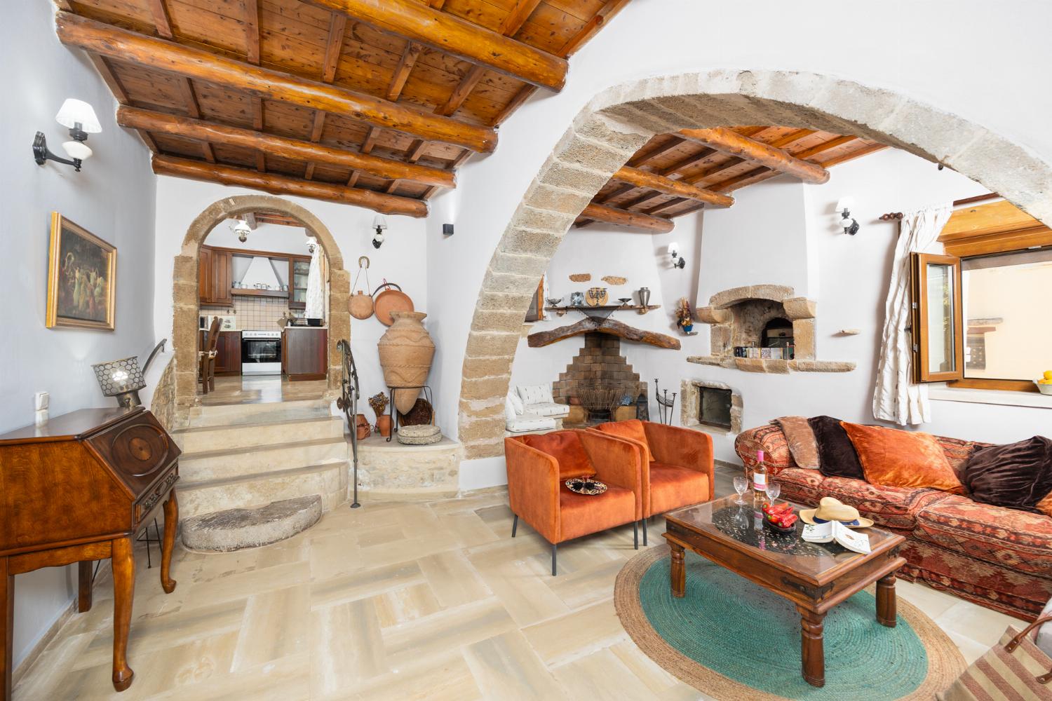 Living room with sofa, ornamental fireplace, A/C, WiFi internet, and satellite TV