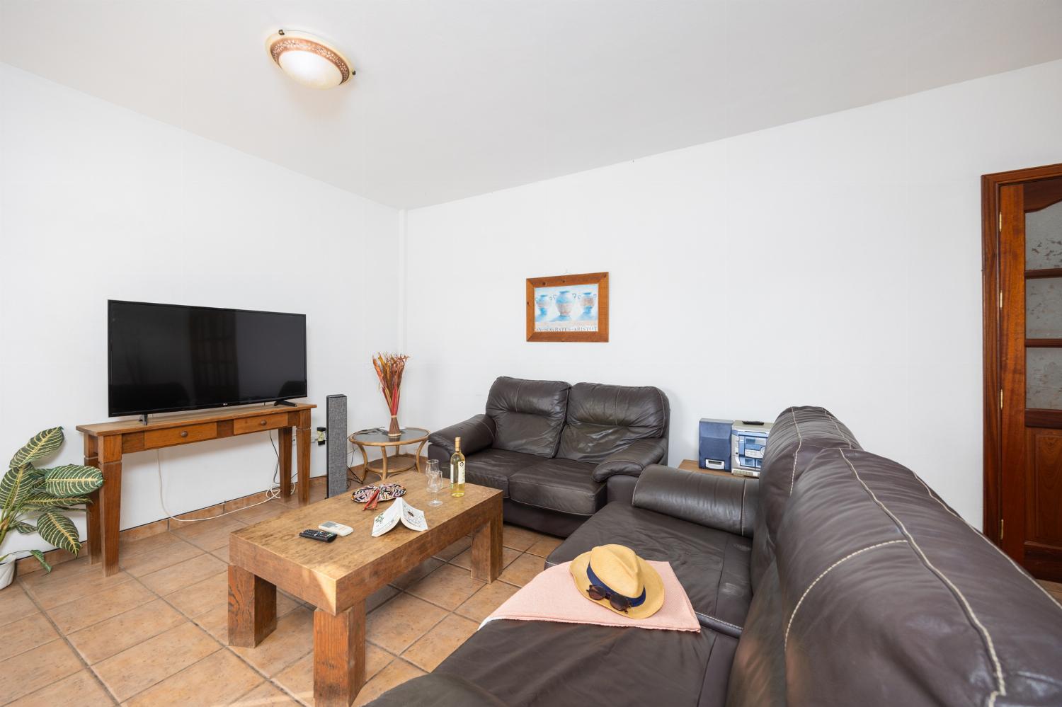 Living room with sofas, dining area, A/C, WiFi internet, and satellite TV
