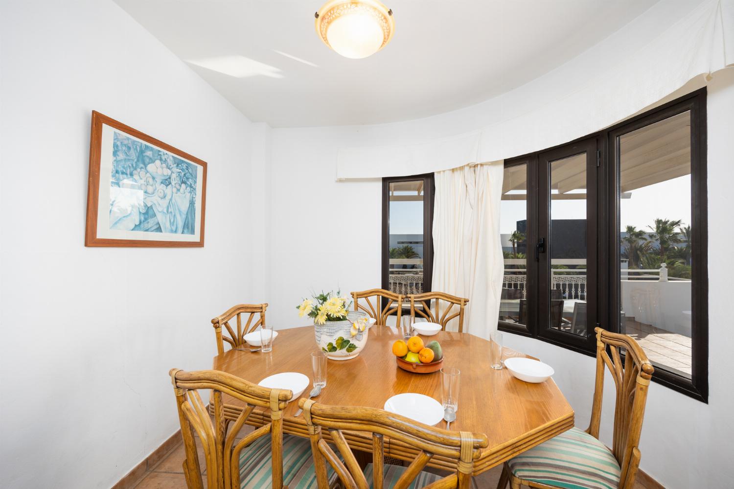 Living room with sofas, dining area, A/C, WiFi internet, and satellite TV