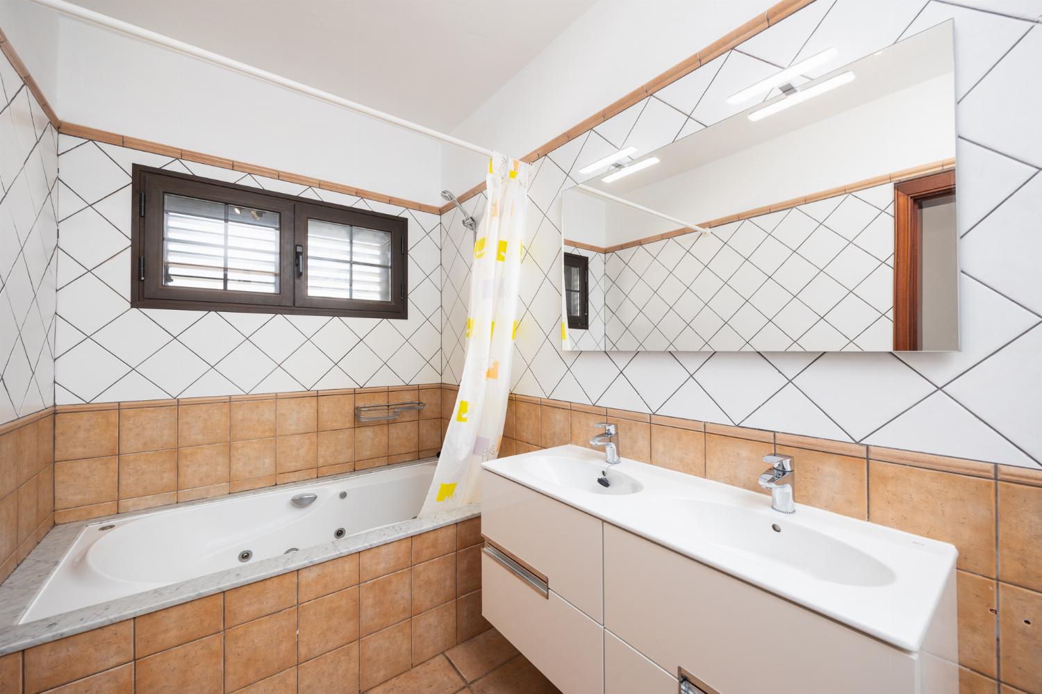 Ensuite bathroom with bath and shower