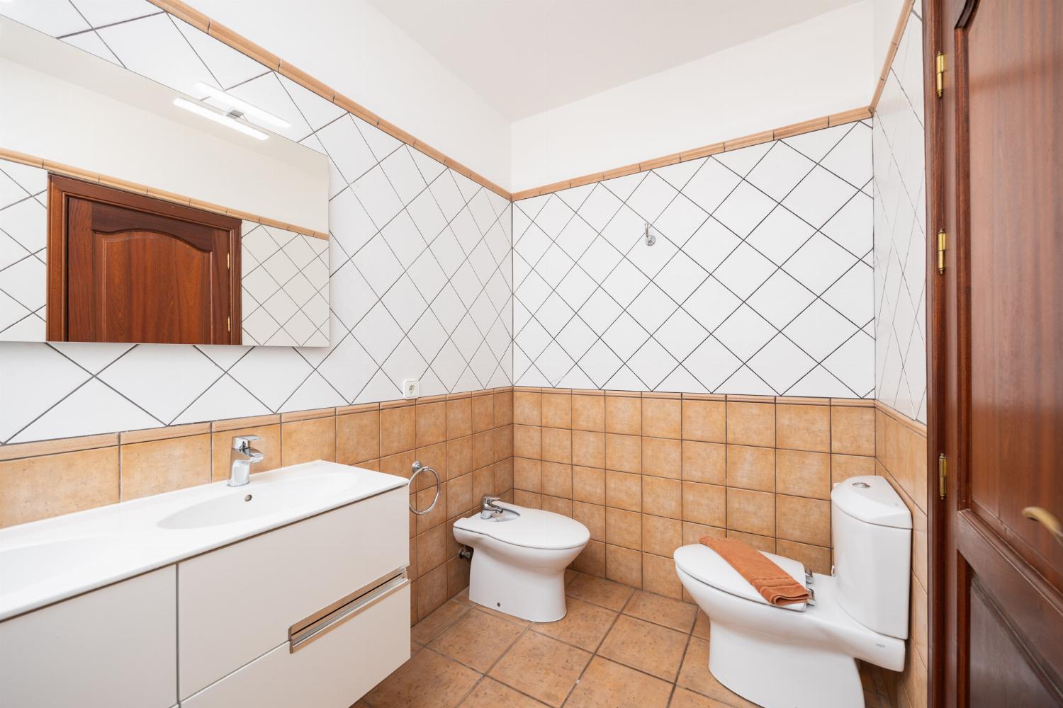Ensuite bathroom with bath and shower