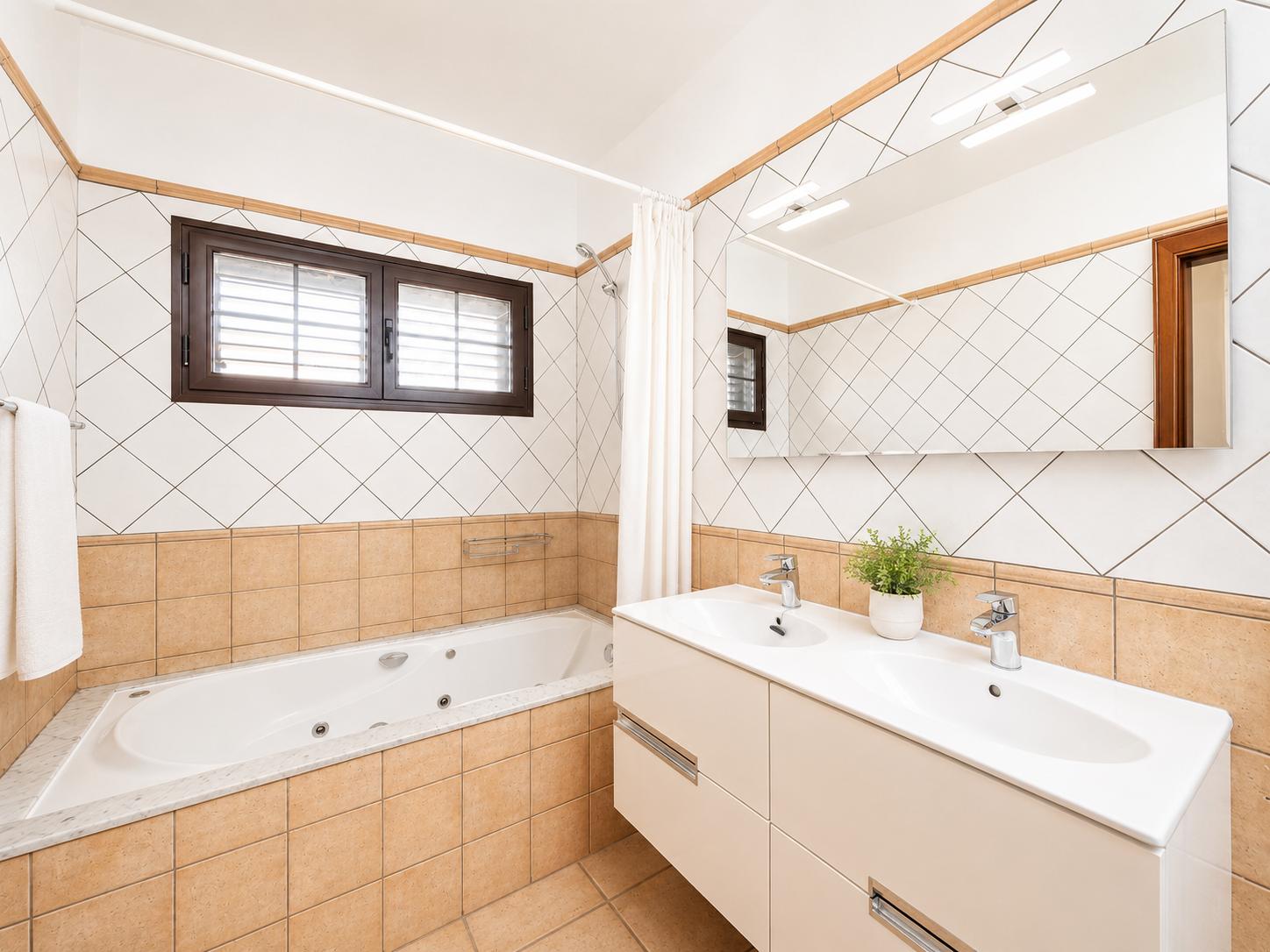 Ensuite bathroom with bath and shower
