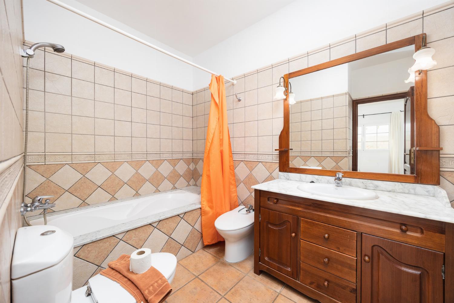En suite bathroom with bath and shower