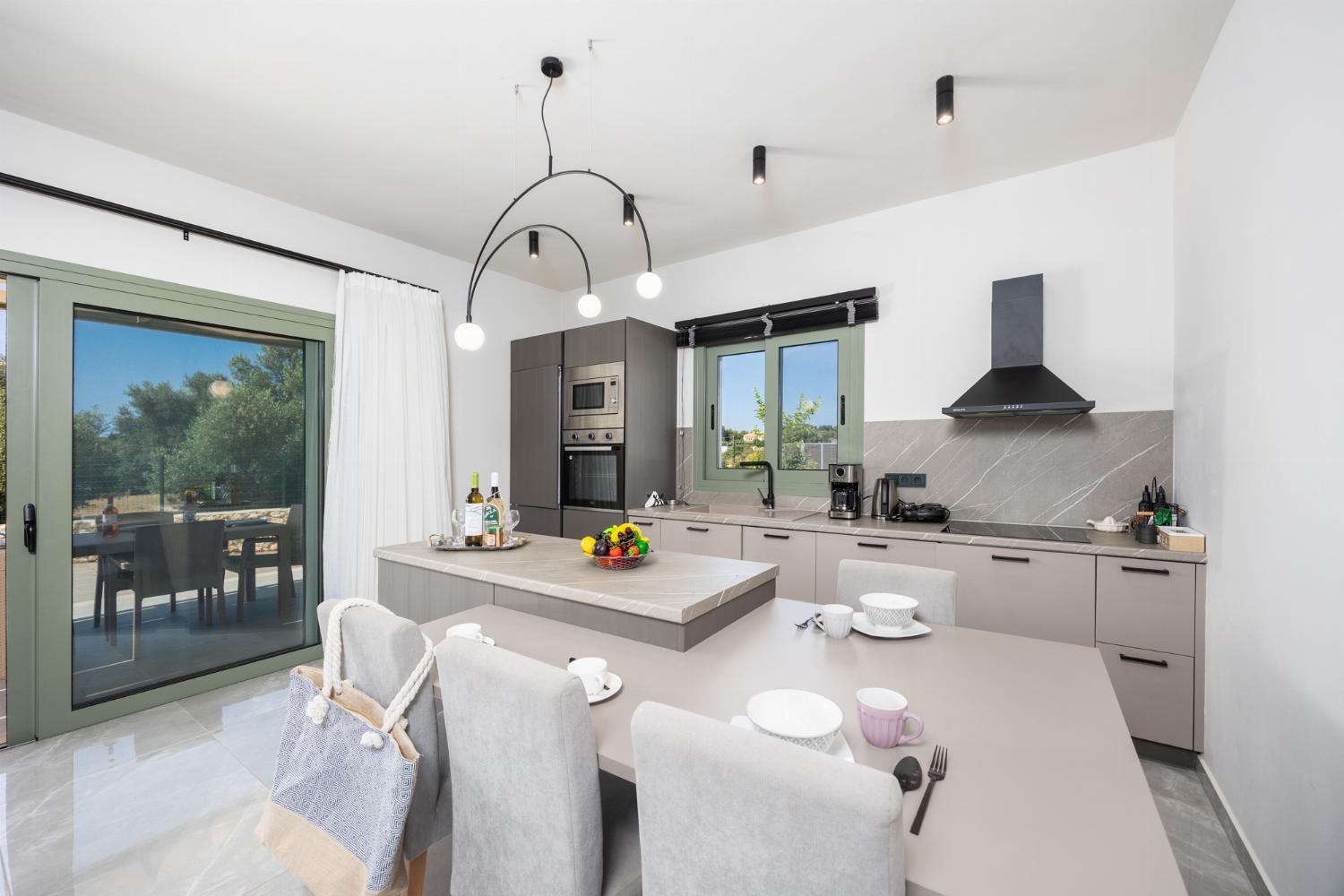 Open-plan living room with sofa, kitchen, A/C, WiFi internet, and satellite TV