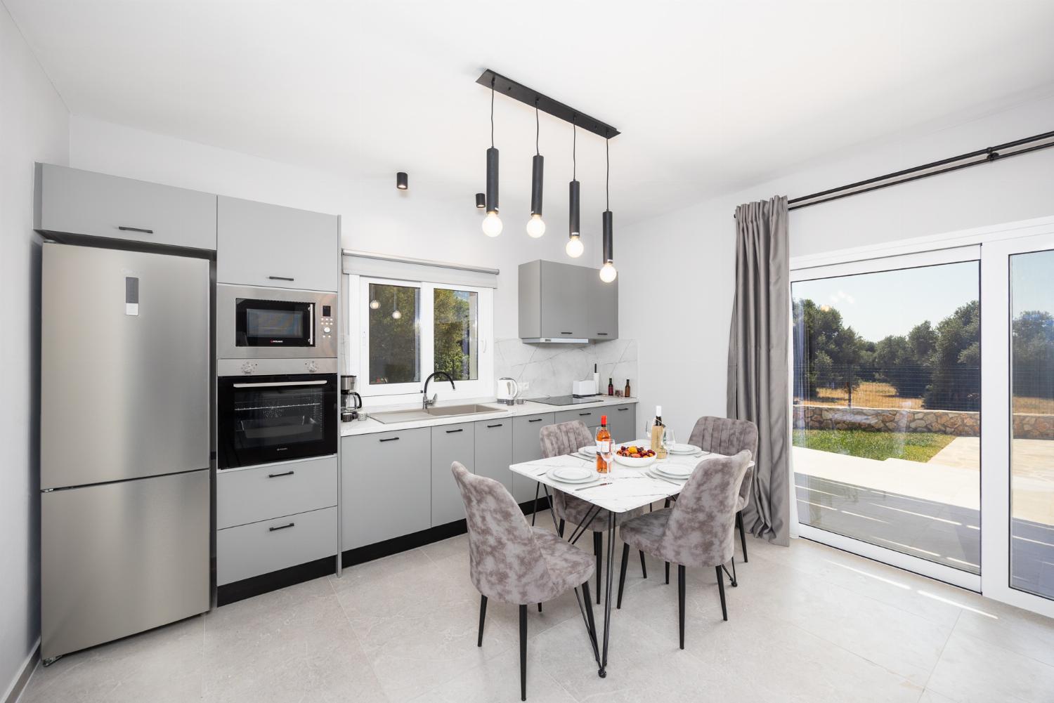 Open-plan living room with sofa, kitchen, A/C, WiFi internet, and satellite TV
