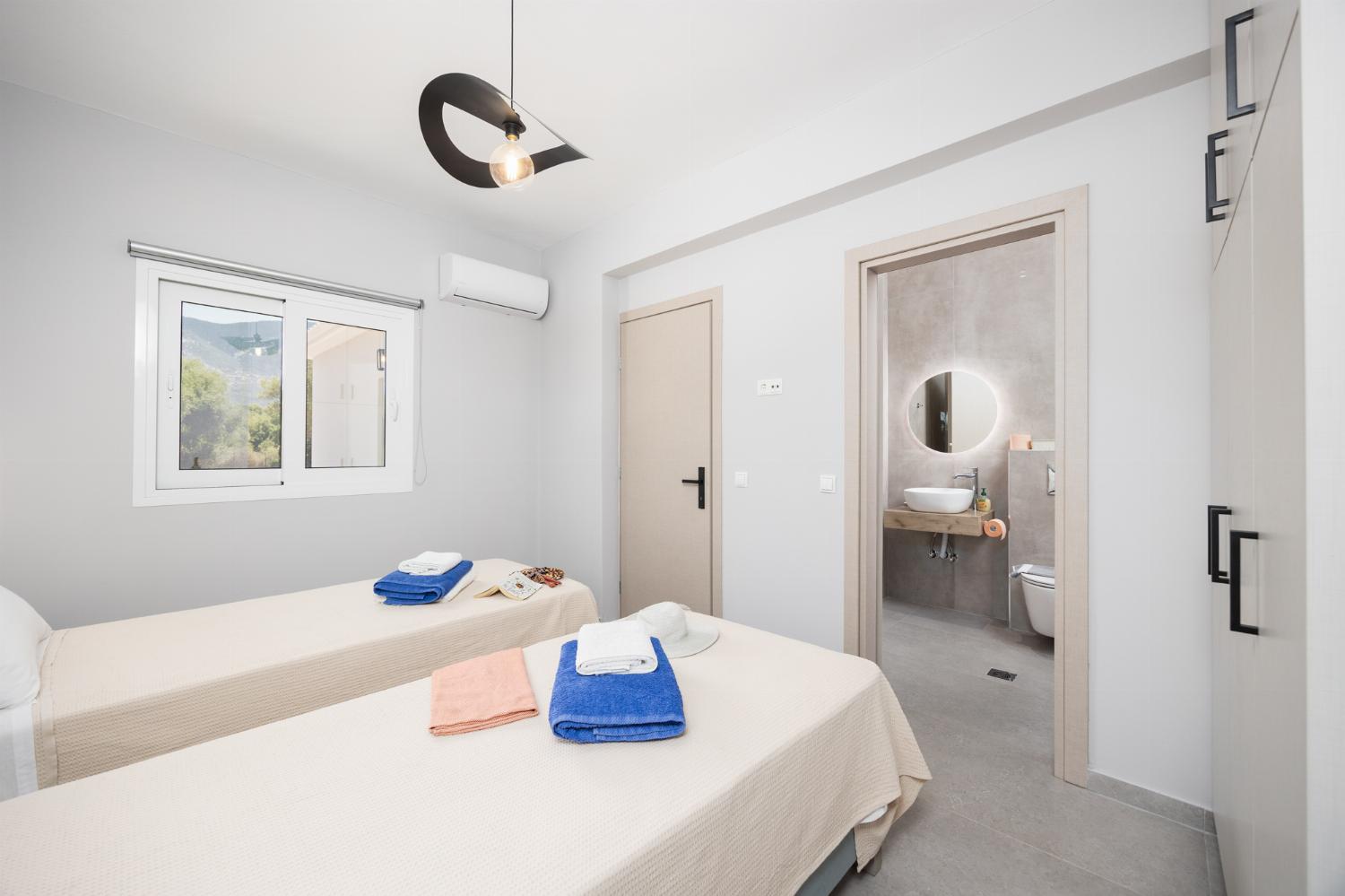 Twin bedroom with en suite bathroom and A/C
