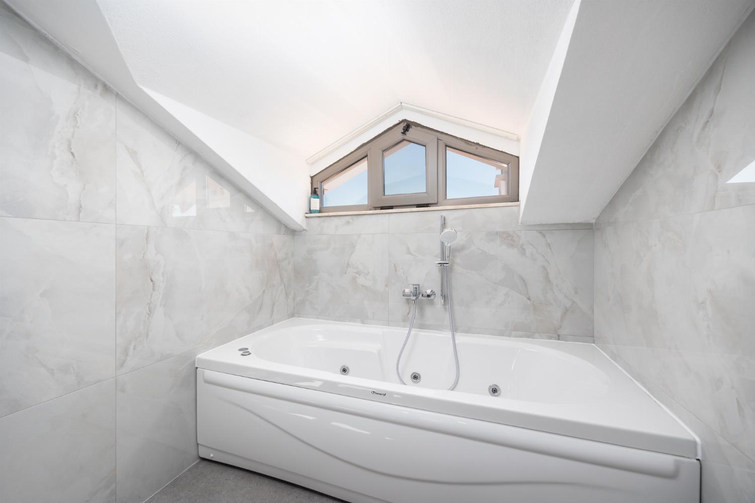 En suite bathroom with bath and shower