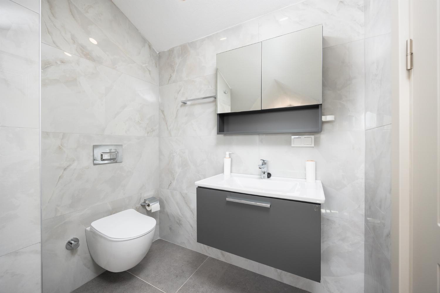 En suite bathroom with bath and shower