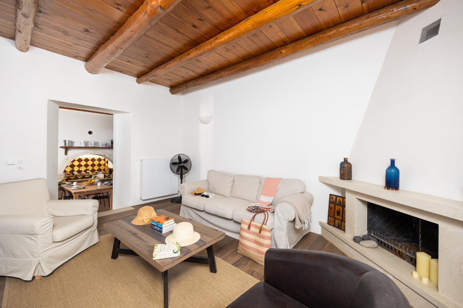 Main building: Living room with sofa, dining area, ornamental fireplace, and WiFi internet