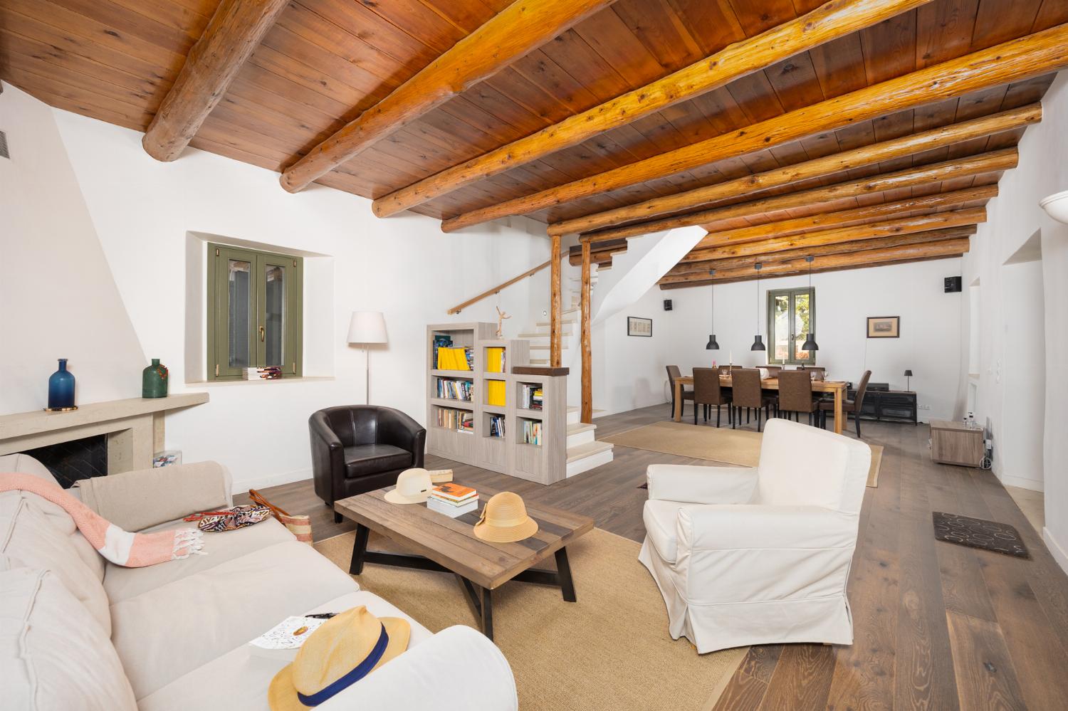 Main building: Living room with sofa, dining area, ornamental fireplace, and WiFi internet
