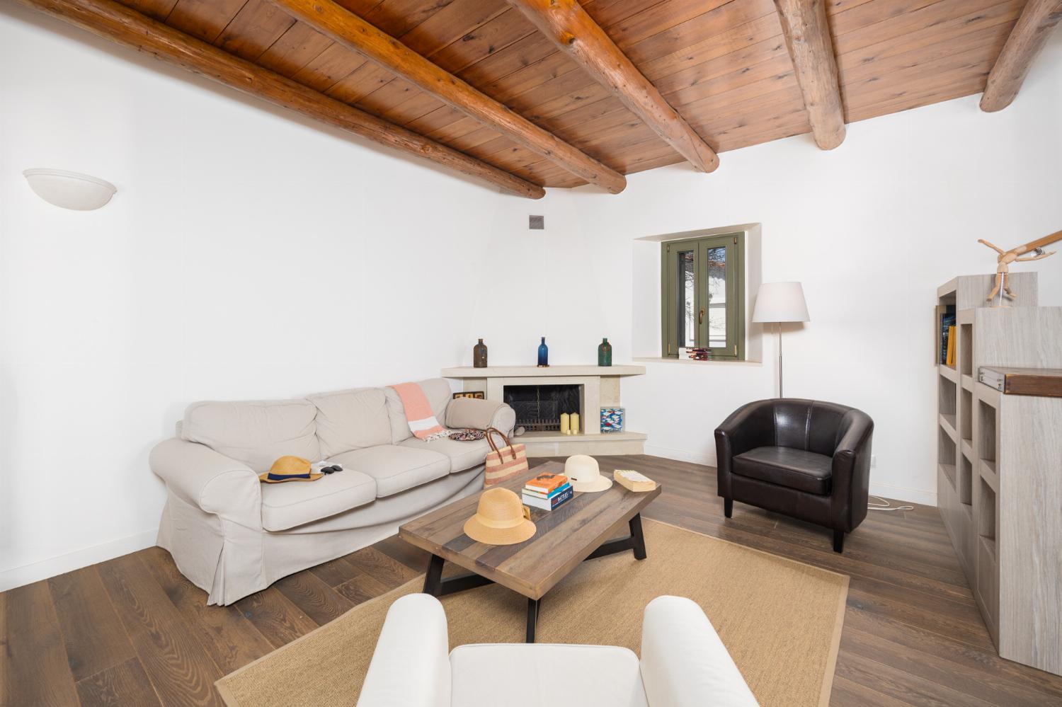Main building: Living room with sofa, dining area, ornamental fireplace, and WiFi internet