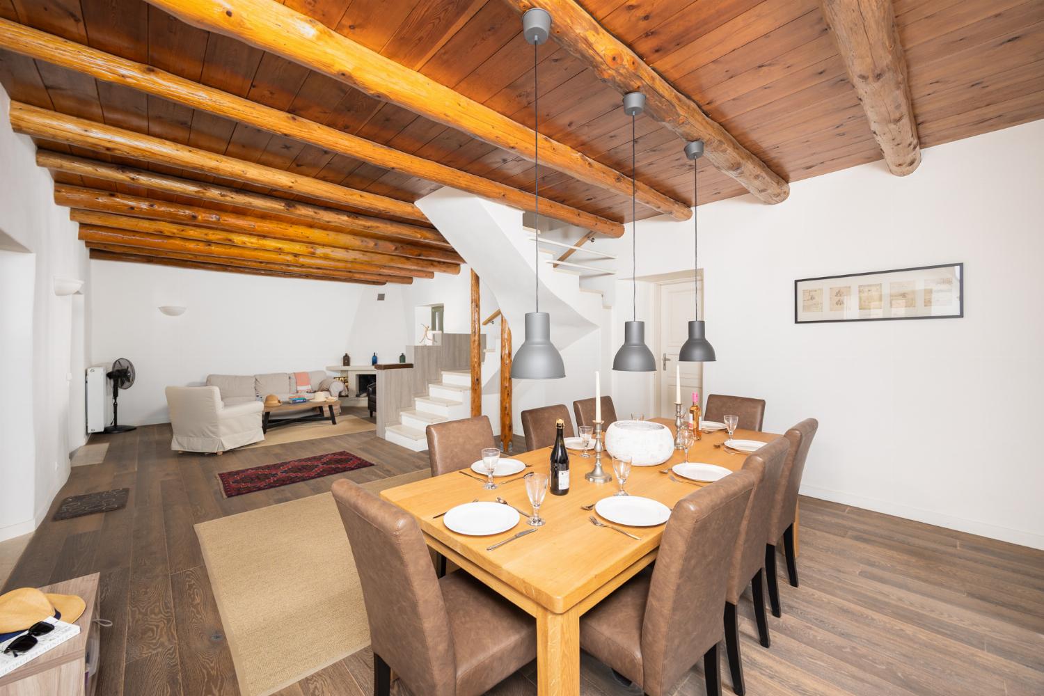 Main building: Living room with sofa, dining area, ornamental fireplace, and WiFi internet