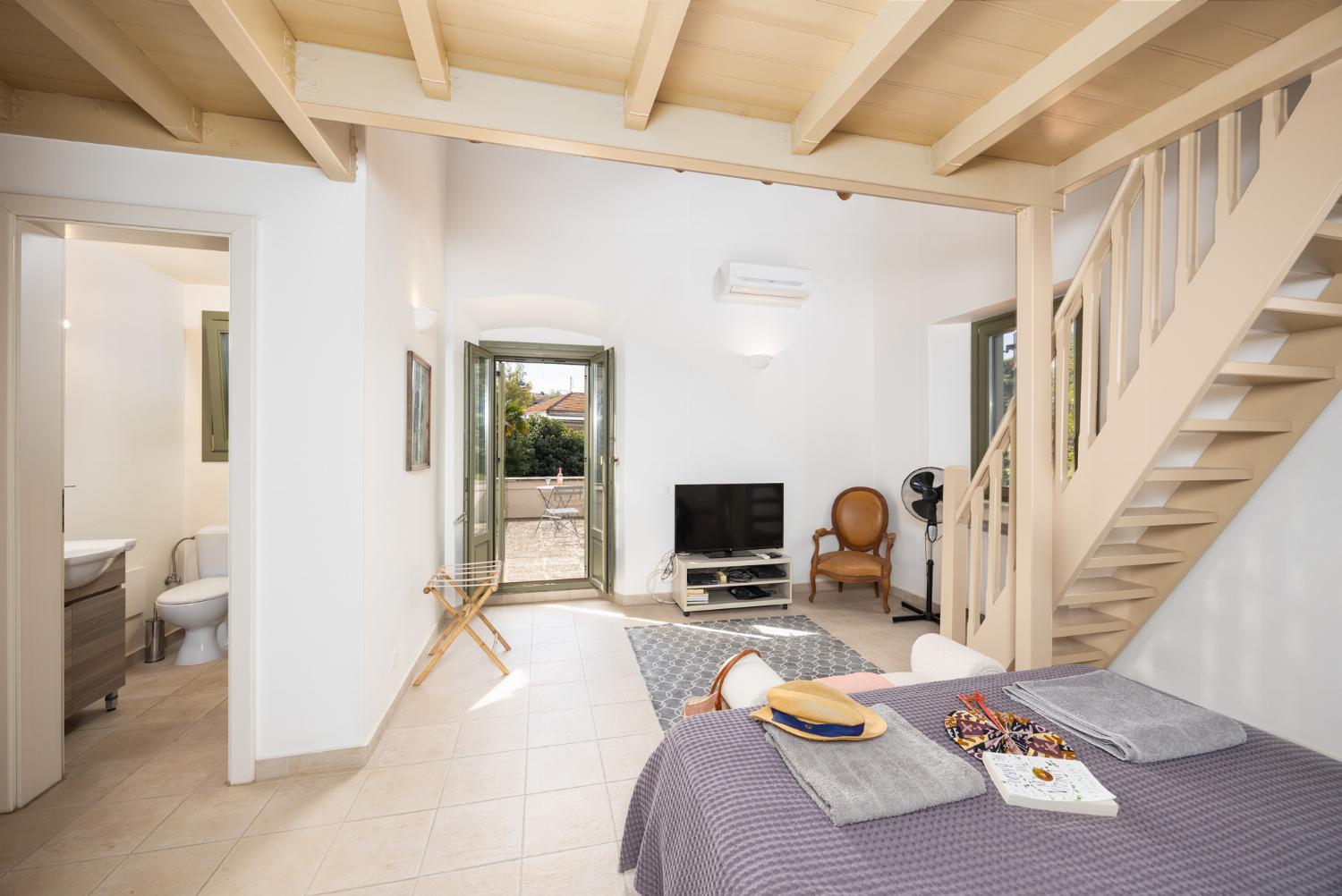 Main building: Bedroom with mezzanine, double bed, sofa-bed, en suite bathroom, and A/C