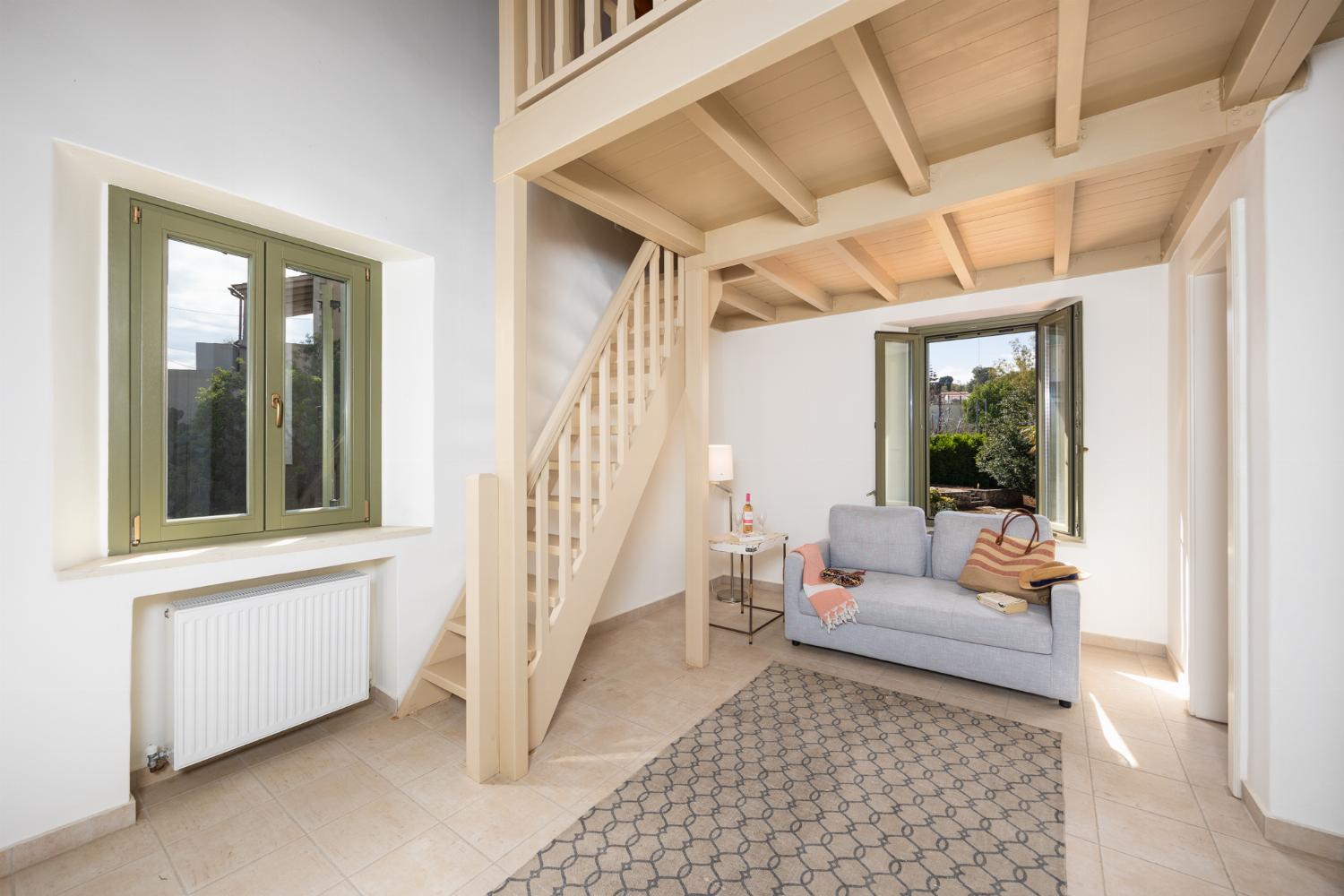 Main building: Bedroom with mezzanine, twin bed, sofa, ensuite bathroom, and A/C