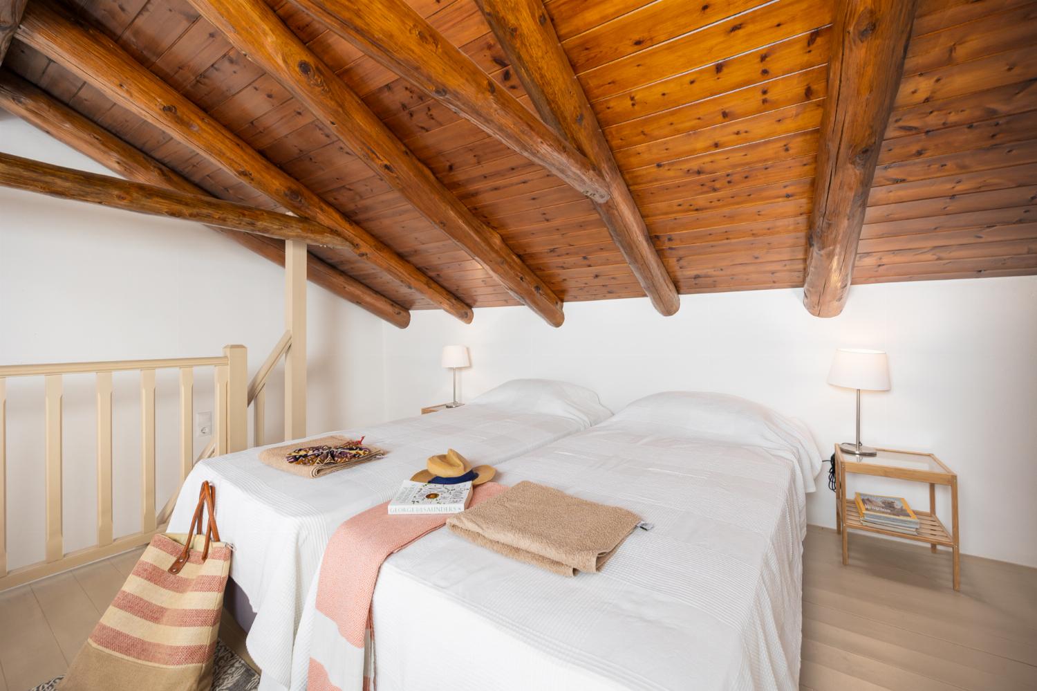 Main building: Bedroom with mezzanine, twin bed, sofa, ensuite bathroom, and A/C