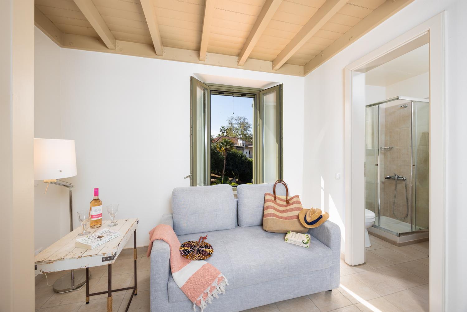Main building: Bedroom with mezzanine, twin bed, sofa, ensuite bathroom, and A/C