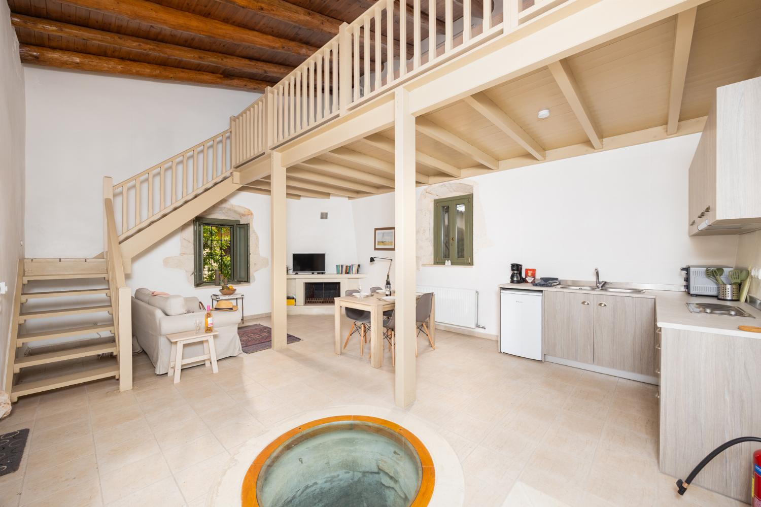 Annex: Open-plan living room with sofa, dining area, kitchen, A/C, WiFi internet, and satellite TV