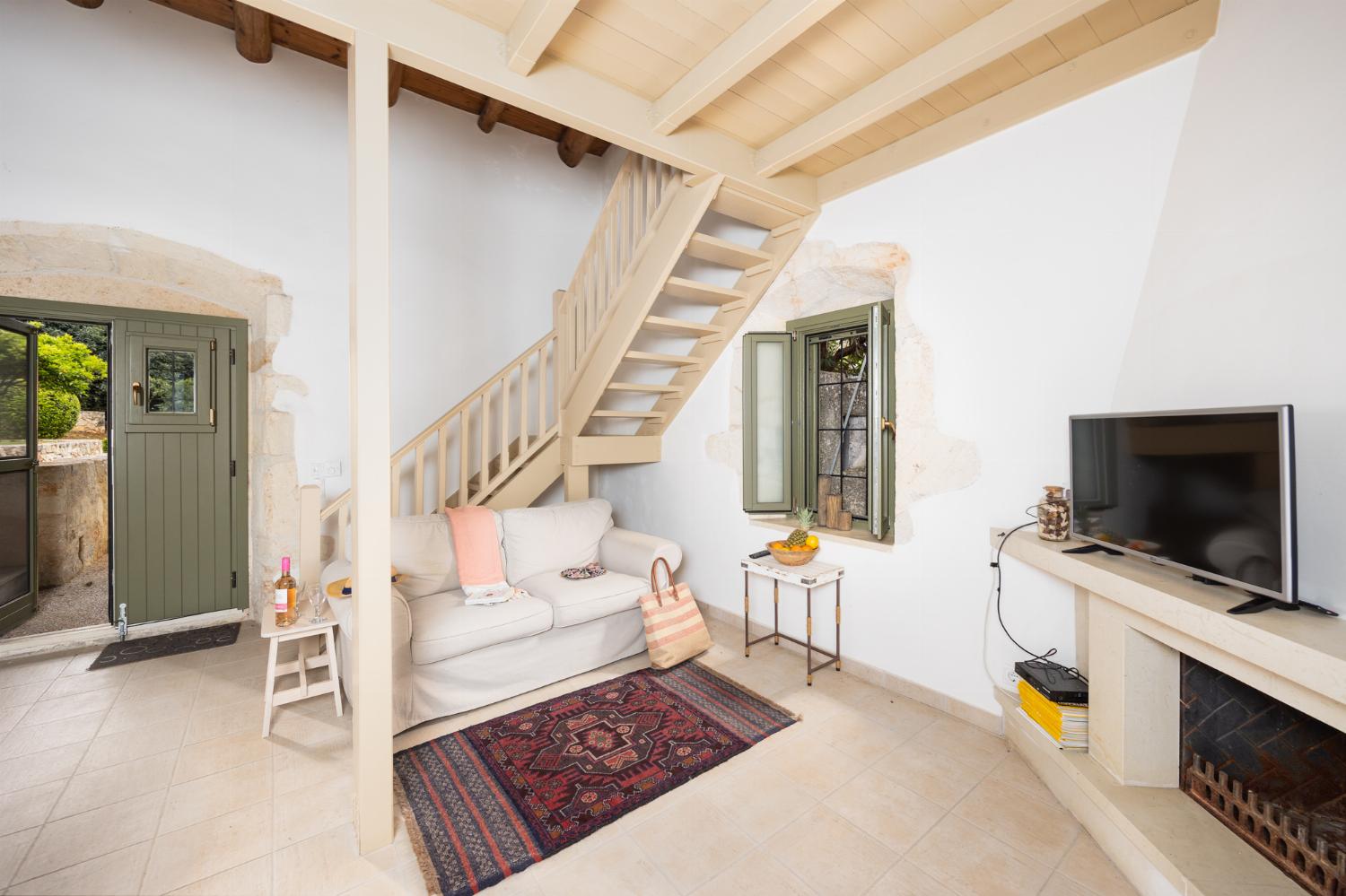 Annex: Open-plan living room with sofa, dining area, kitchen, A/C, WiFi internet, and satellite TV