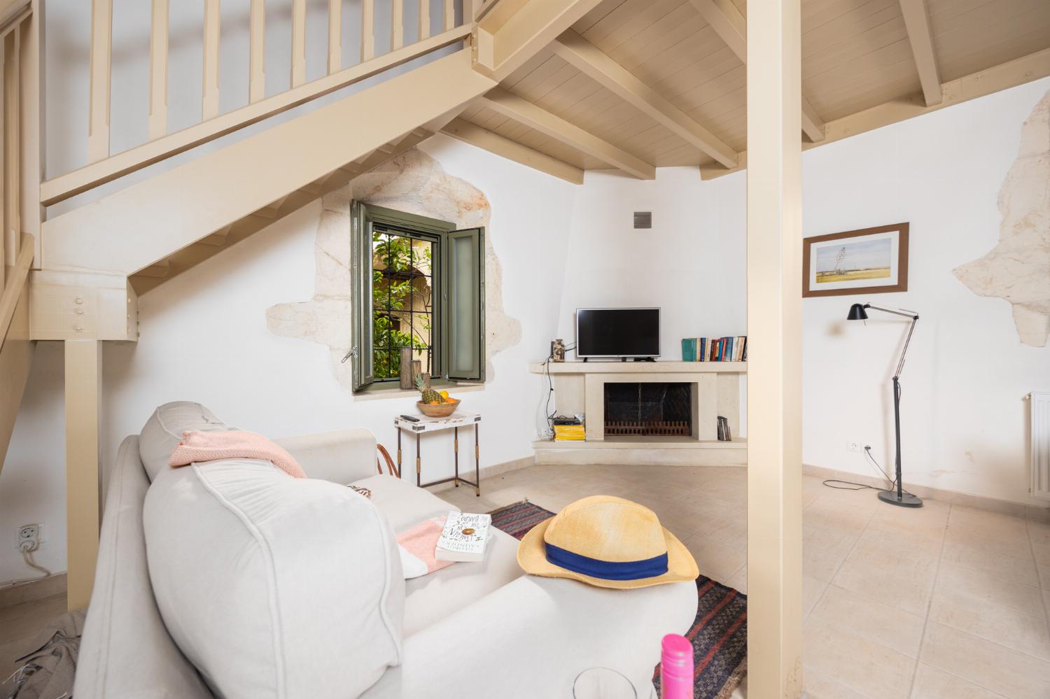 Annex: Open-plan living room with sofa, dining area, kitchen, A/C, WiFi internet, and satellite TV