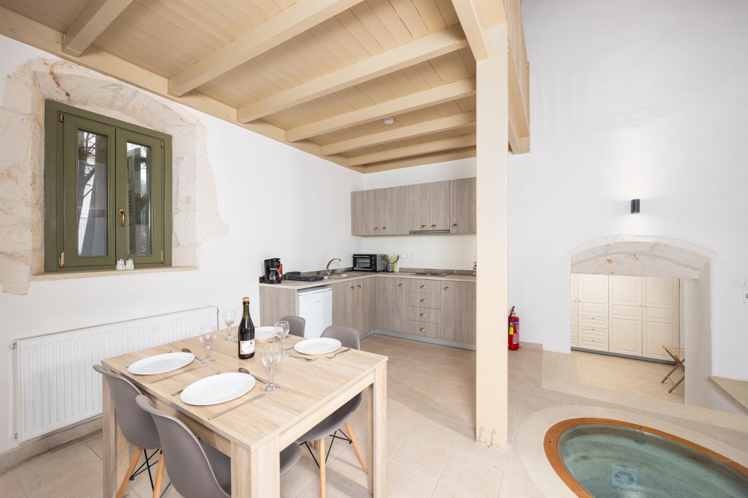 Annex: Open-plan living room with sofa, dining area, kitchen, A/C, WiFi internet, and satellite TV