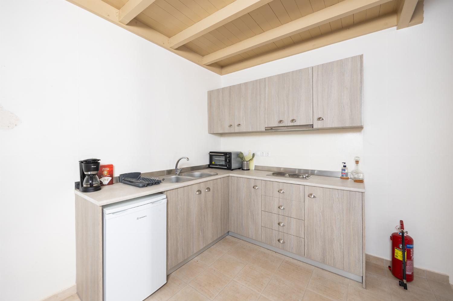 Annex: Open-plan living room with sofa, dining area, kitchen, A/C, WiFi internet, and satellite TV