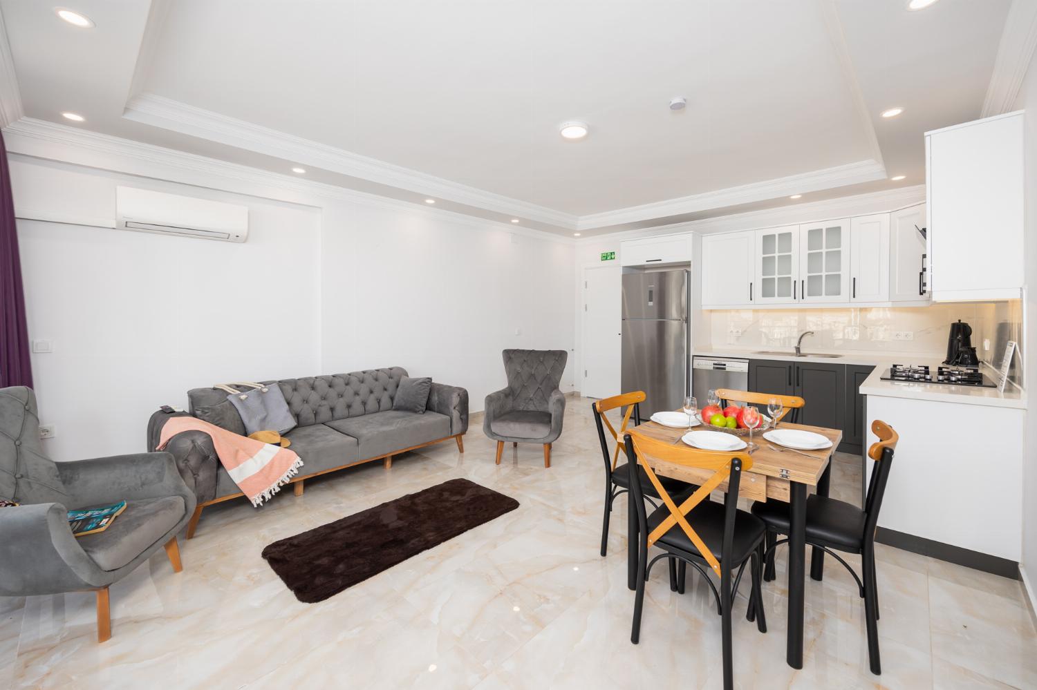 Annex: open-plan living room with sofa, dining area, kitchen, A/C, WiFi internet, and satellite TV