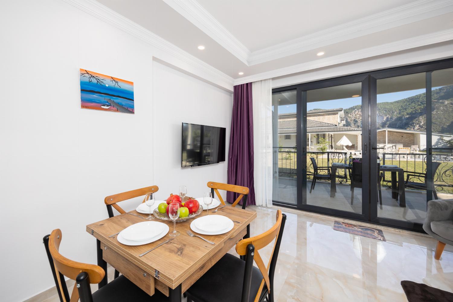 Annex: open-plan living room with sofa, dining area, kitchen, A/C, WiFi internet, and satellite TV